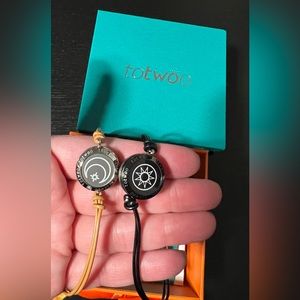 Set of 2 Totwoo bracelets. Black leather has Sun and tan leather has Moon.